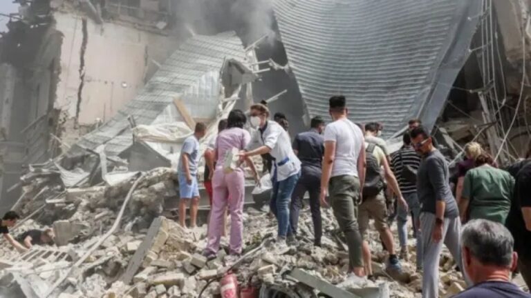 A human chain removes rubble from a hospital in Kyiv