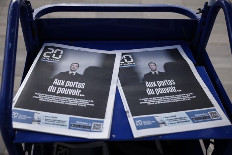 A portrait of the president of the French right-wing party National Rally (Rassemblement National, RN), Jordan Bardella, appears on the front page of a newspaper in Paris