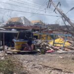 Destroyed houses and a fallen electricity mast due to Hurricane Beryl, in Saint Vincent and the Grenadines, Caribbean.