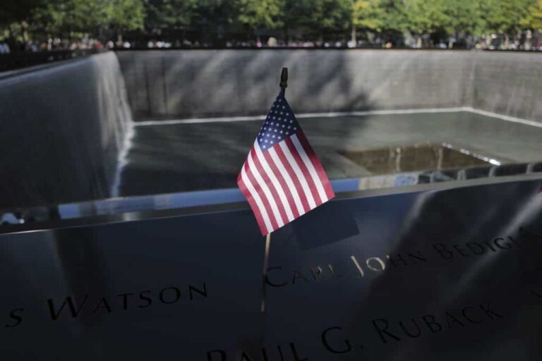 A flag is placed next to the names of those killed during the Sept. 11, 2001, attacks, in the reflecting pools at the National September 11 Memorial & Museum, Tuesday, Sept. 10, 2024, in New York.