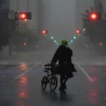 Ron Rook, who said he was looking for people who might need his help or debris to remove, walks in the rain and wind in the desert central Tampa before Hurricane Milton makes landfall in Florida on Oct. 9, 2024.